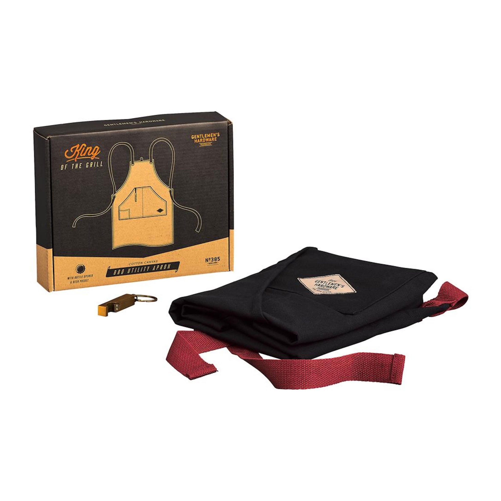 Folded black BBQ apron with red straps beside its box and a gold bottle opener on a key ring