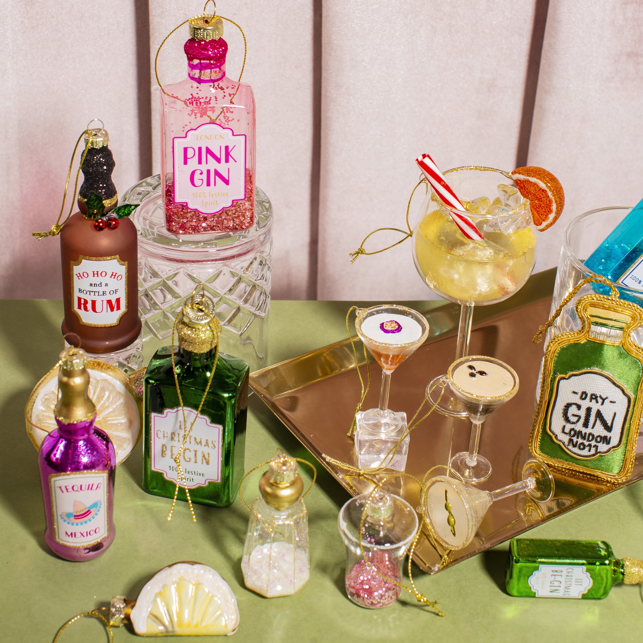 Glass tequila bottle and lemon slice among other bar-themed decorations