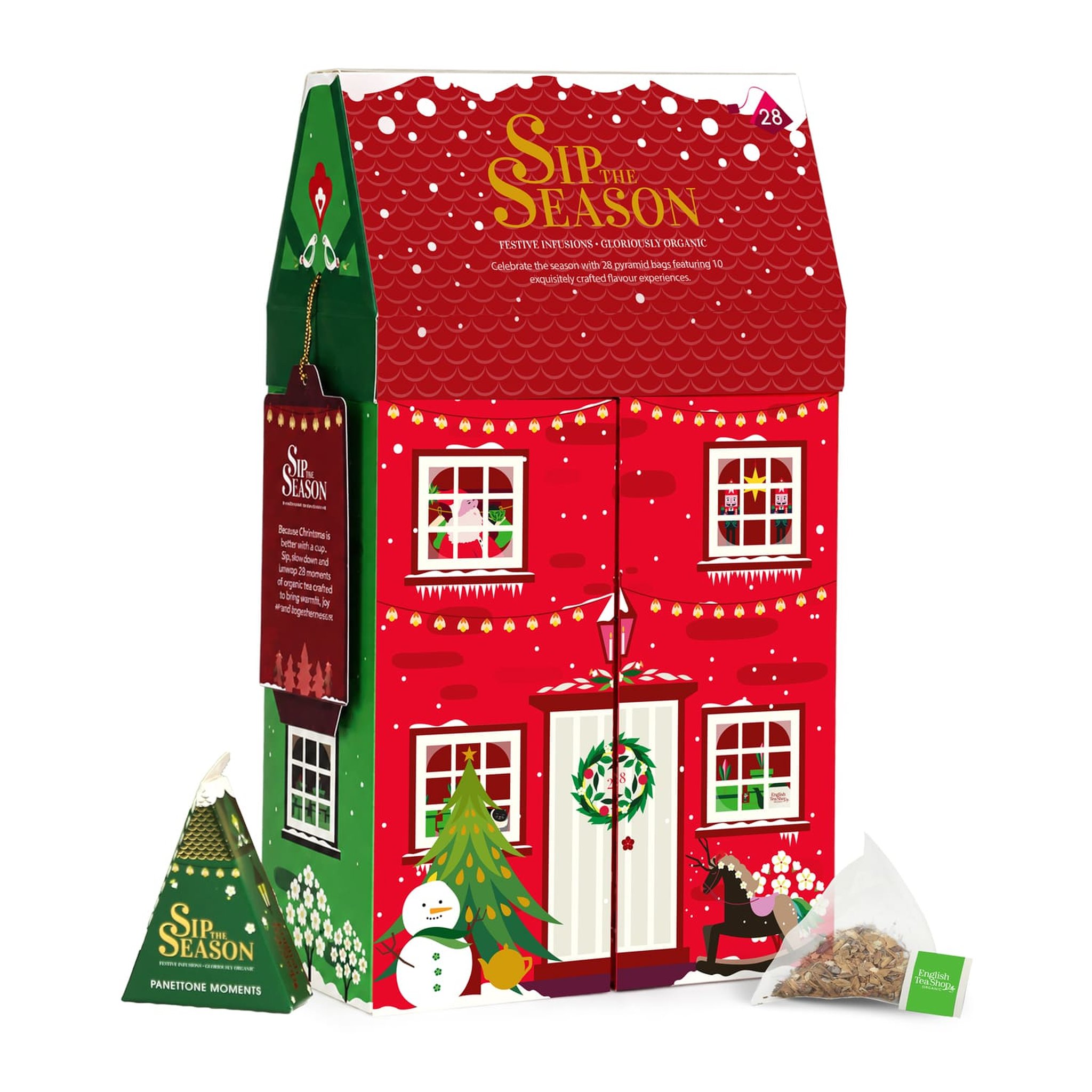 Boîte à thé en forme de maison avec une pyramide verte et un sachet pyramide devant