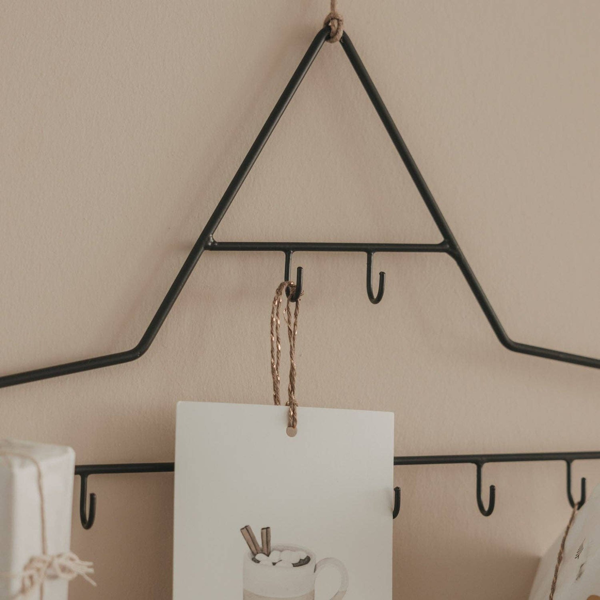 Detail of the black metal star tip with hooks and a card hanging on twine