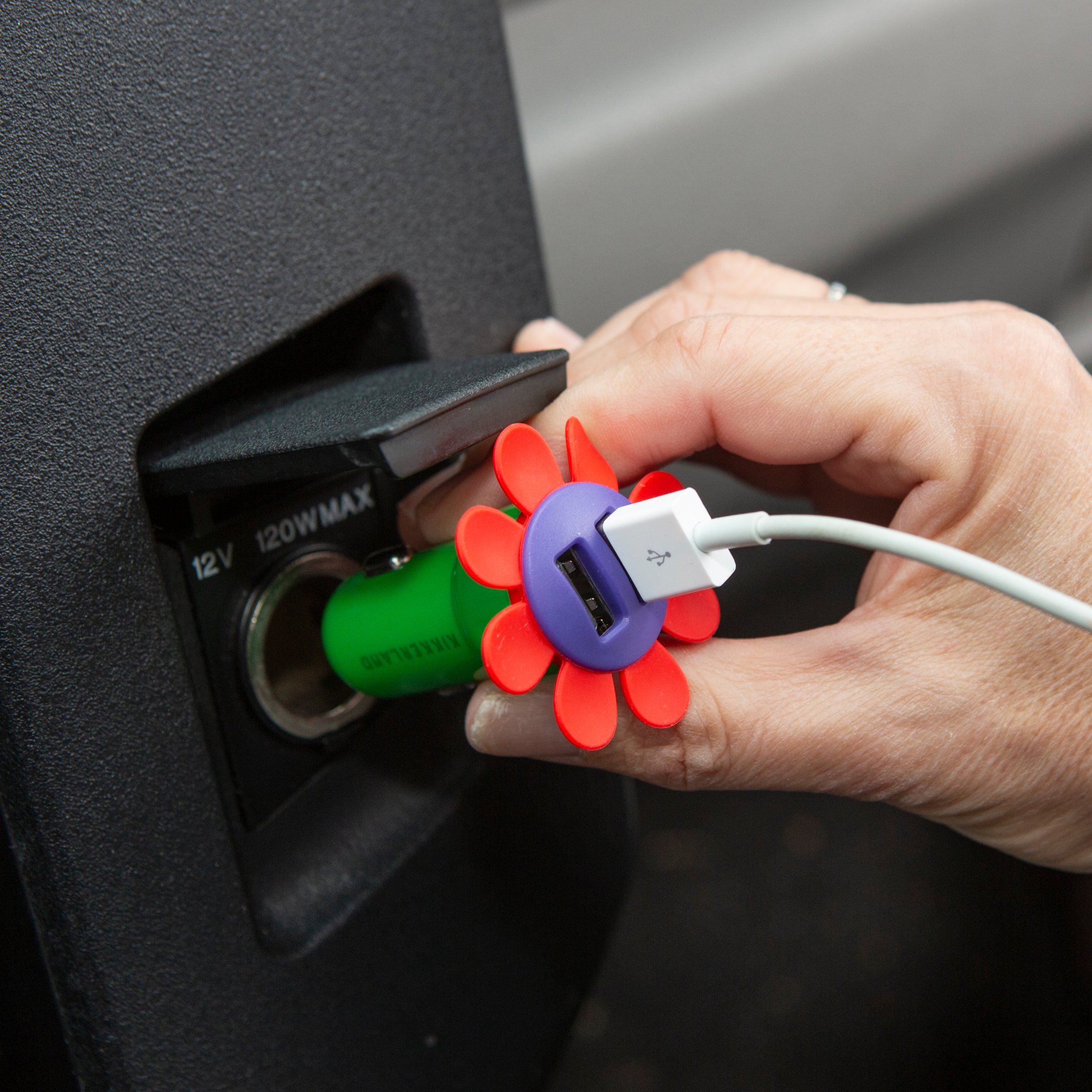 Hand plugging a USB cable into the flower car charger