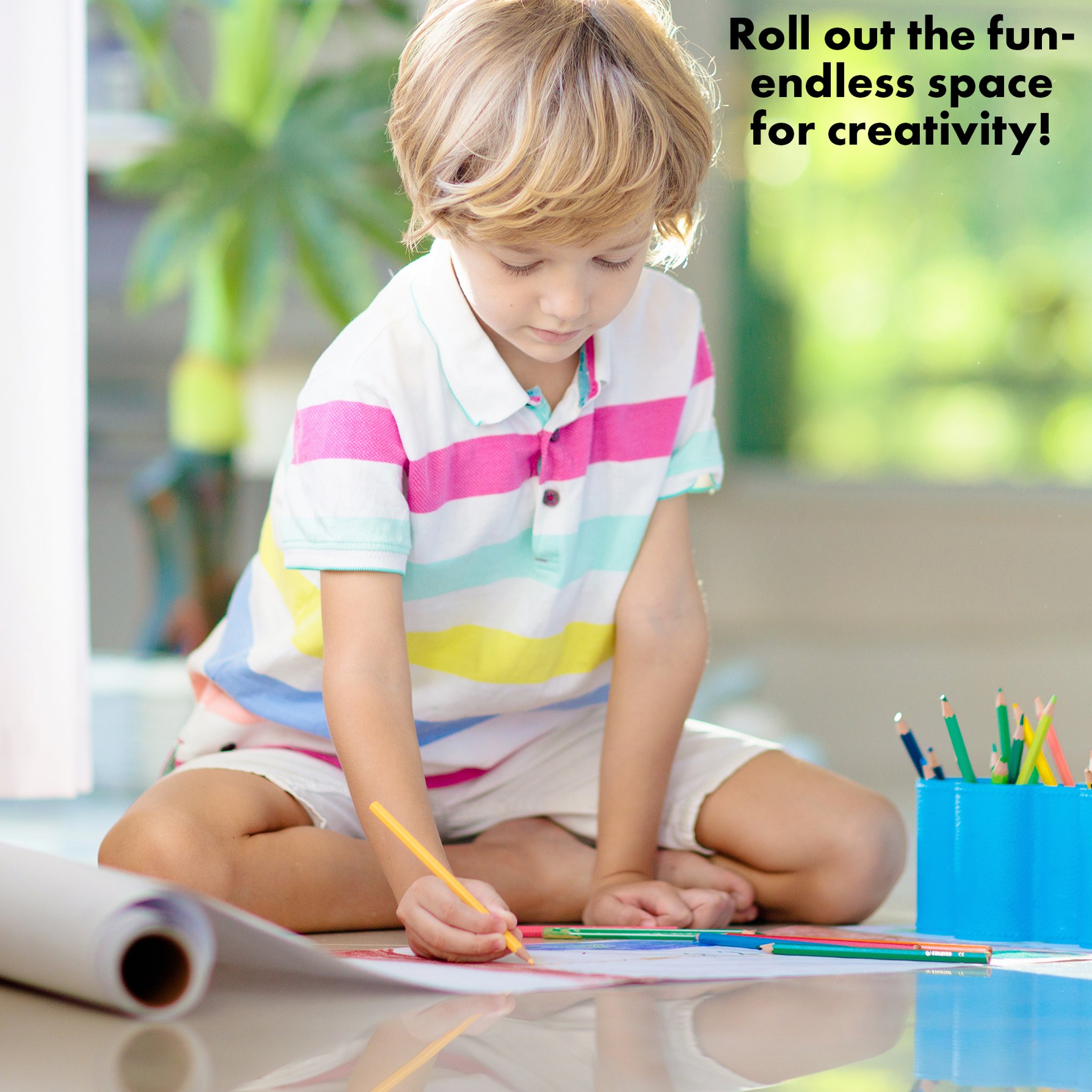 Boy drawing on the floor on the abeec paper roll