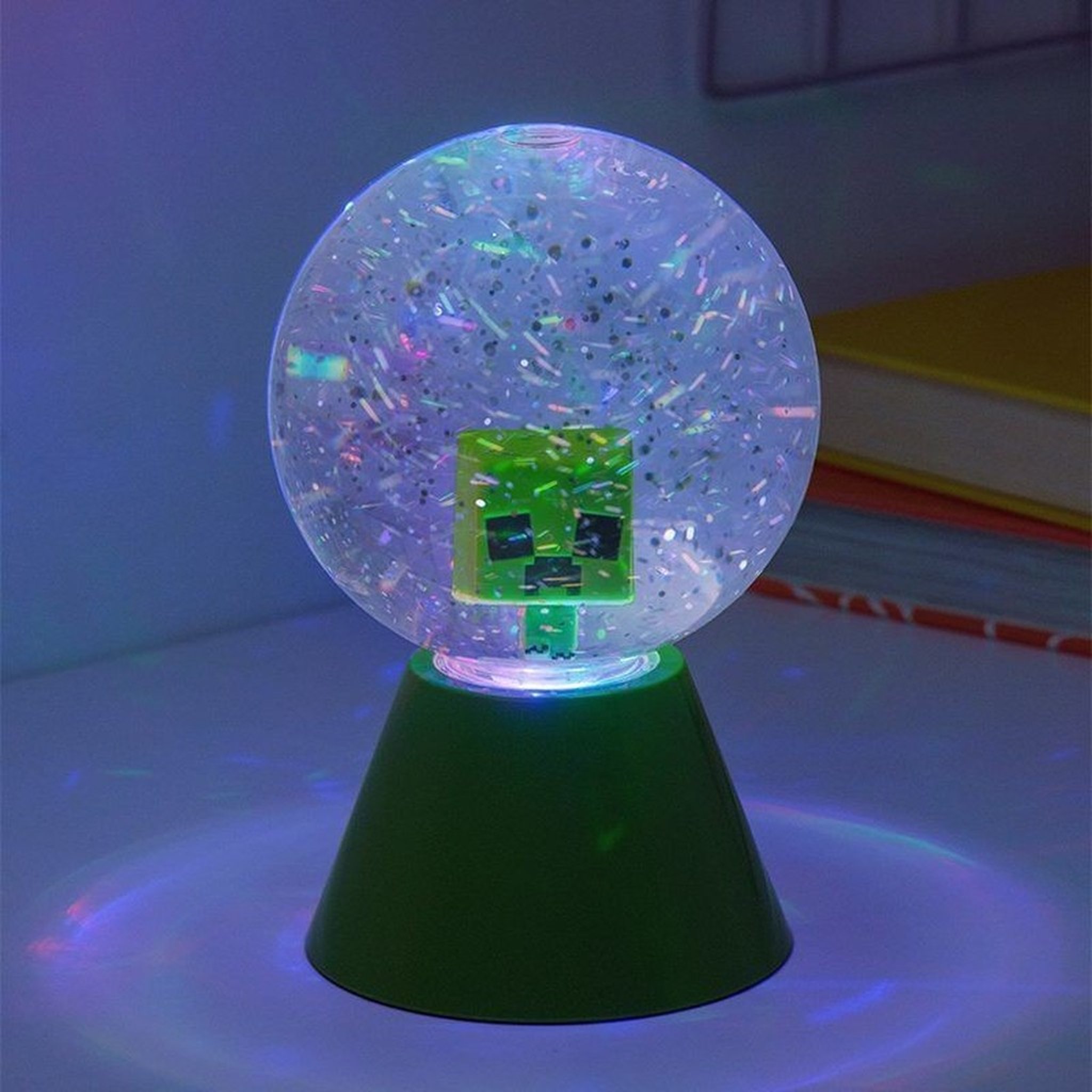 Minecraft snow globe glowing with the Creeper face in glitter water