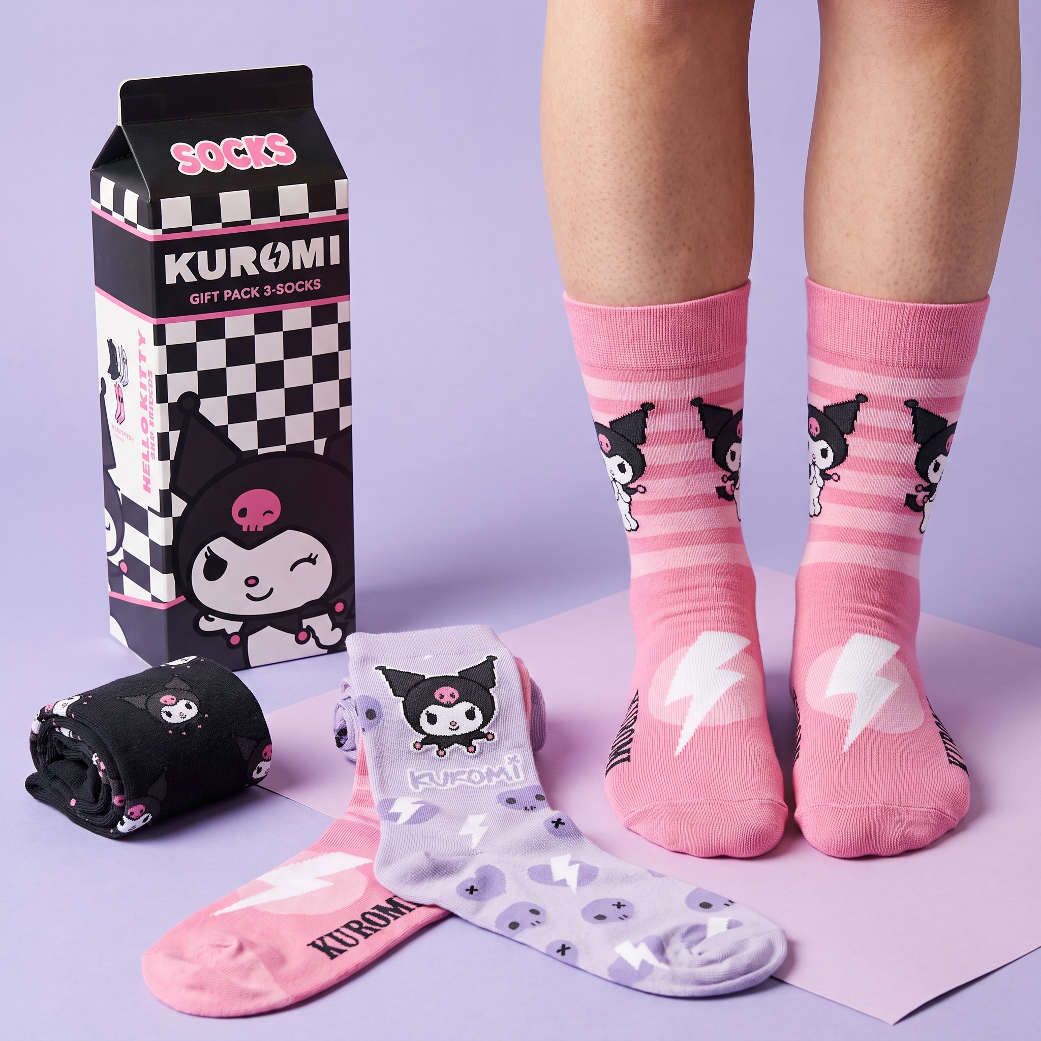 Kuromi sock gift set with milk carton box, pink striped pair worn and black and lilac socks laid out