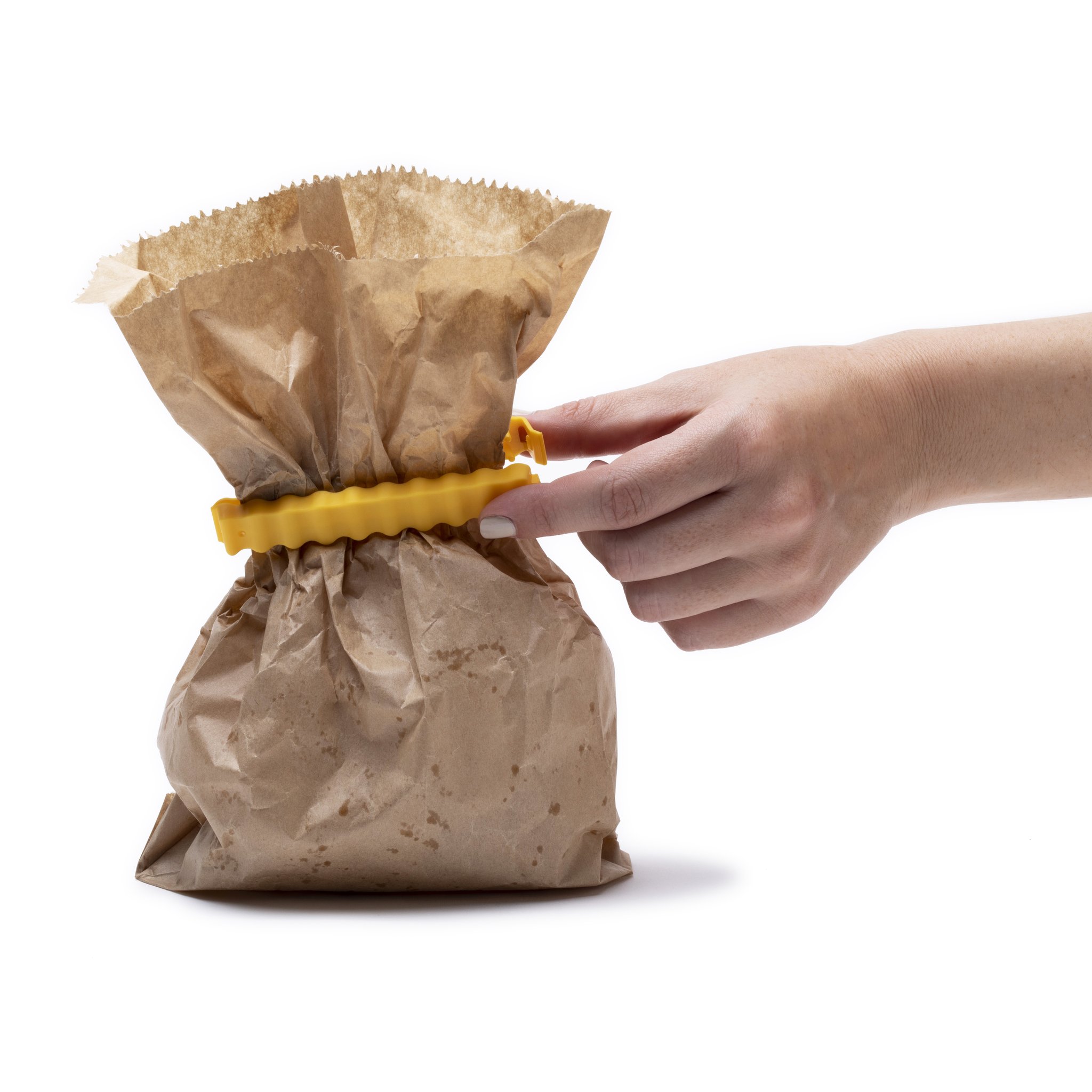 Hand verschliesst Papier-Brötchentüte mit gelber Pommes-Klammer