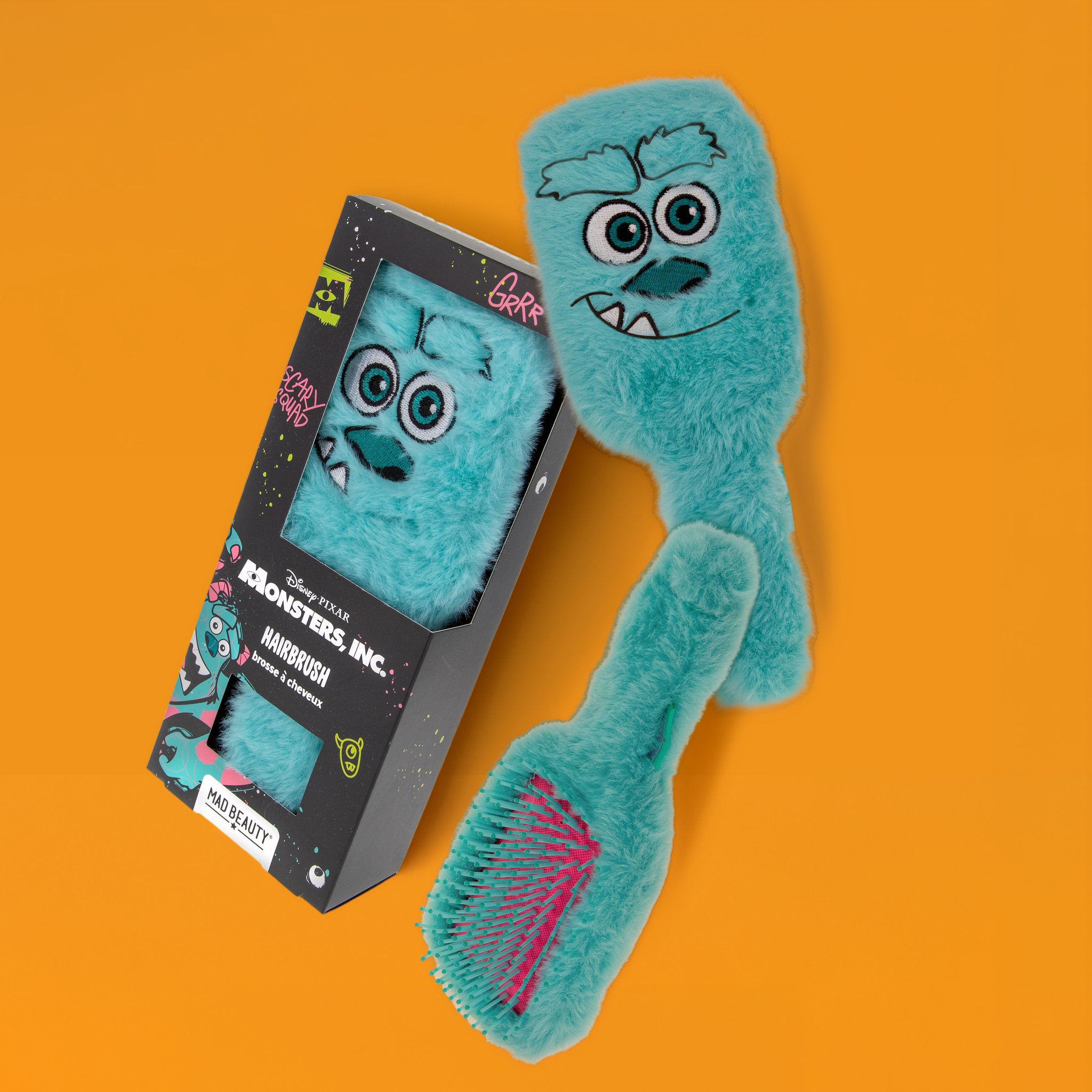 Sulley brush with fluffy plush back and pink bristles next to the Monsters, Inc. pack