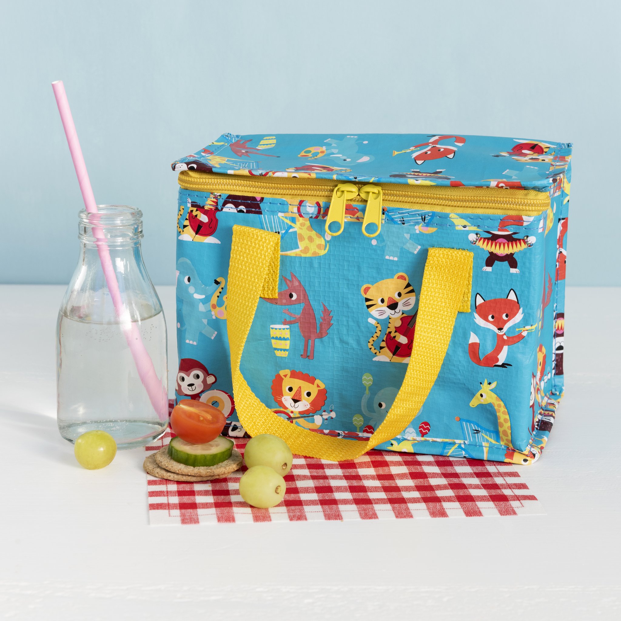 Animal band lunch bag with milk bottle and snack on checked cloth