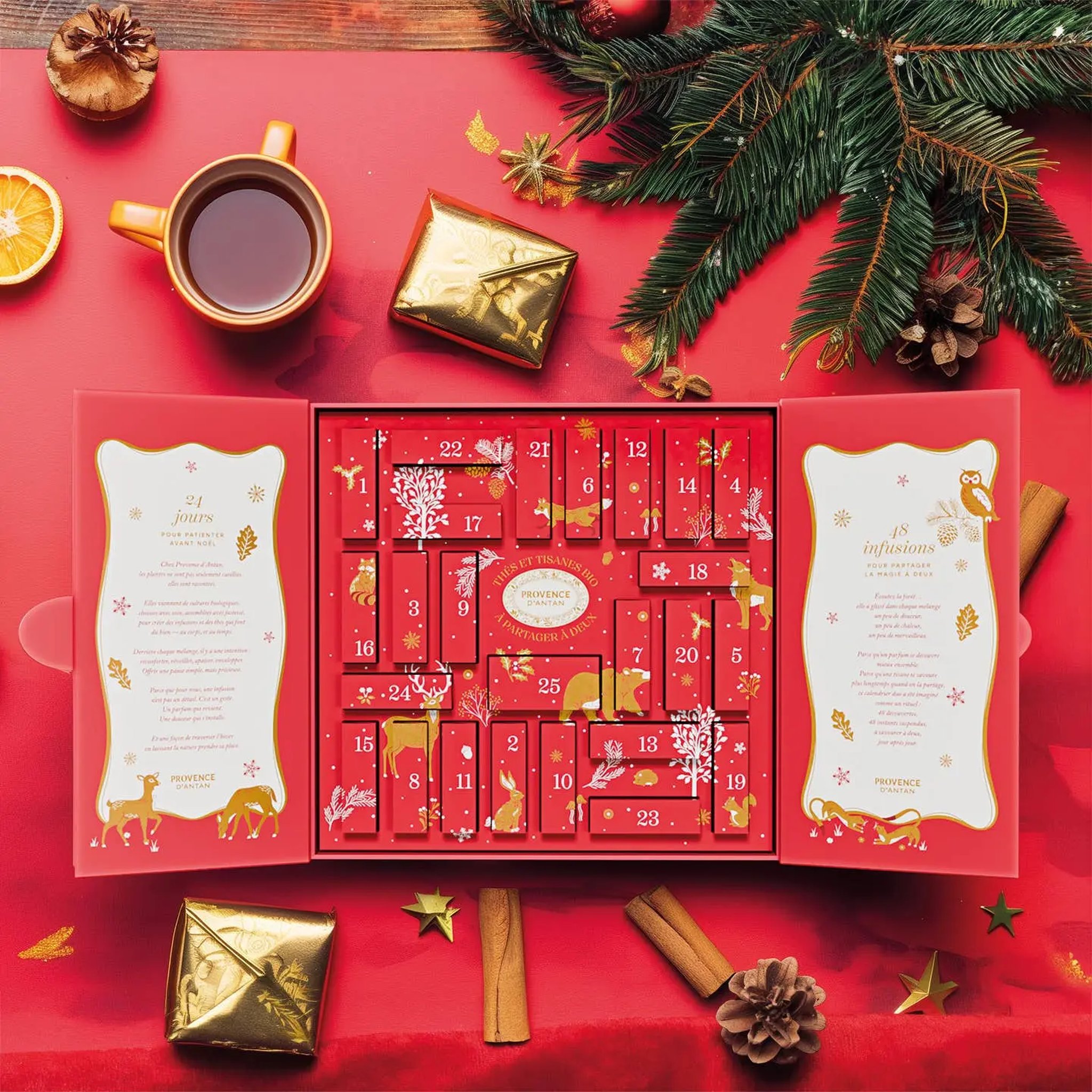Calendario dell'Avvento Duo aperto con tazza di tè, cannella e rami di abete