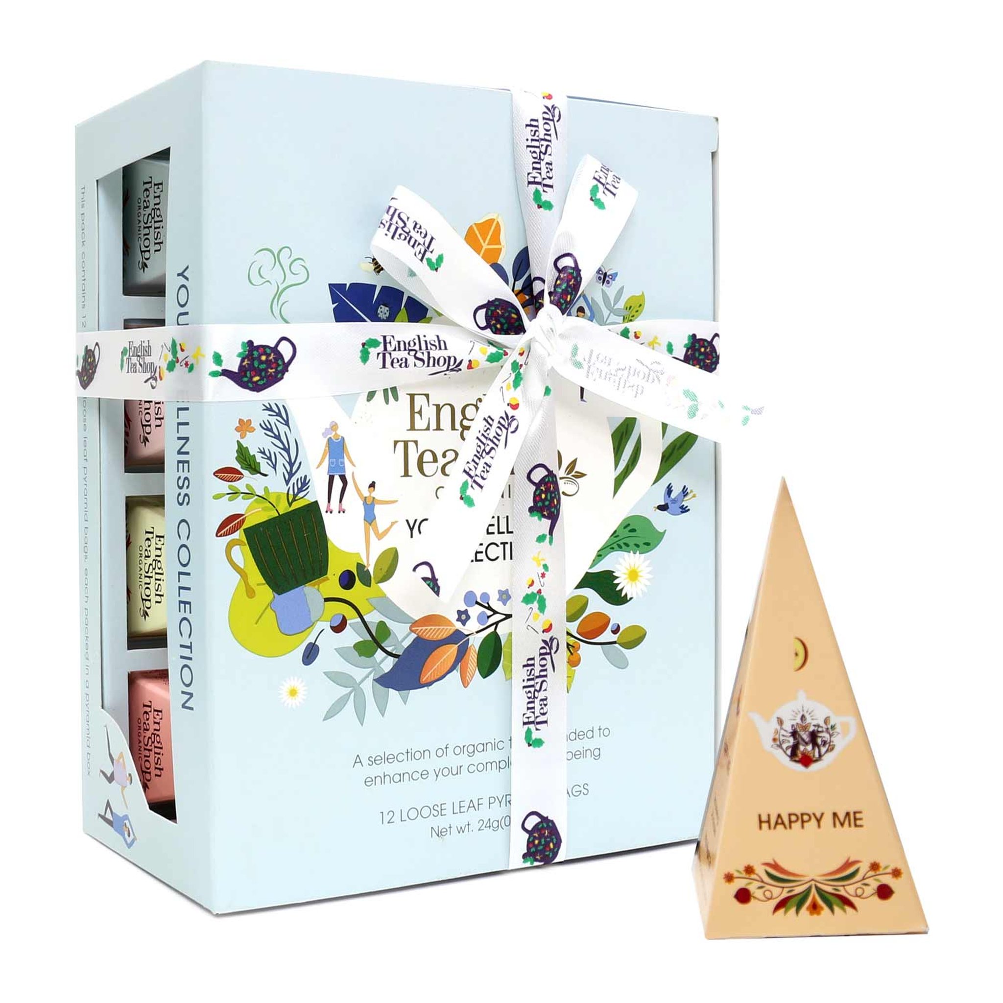 Coffret de thés bien-être de biais, à côté d'une pyramide couleur pêche Happy Me