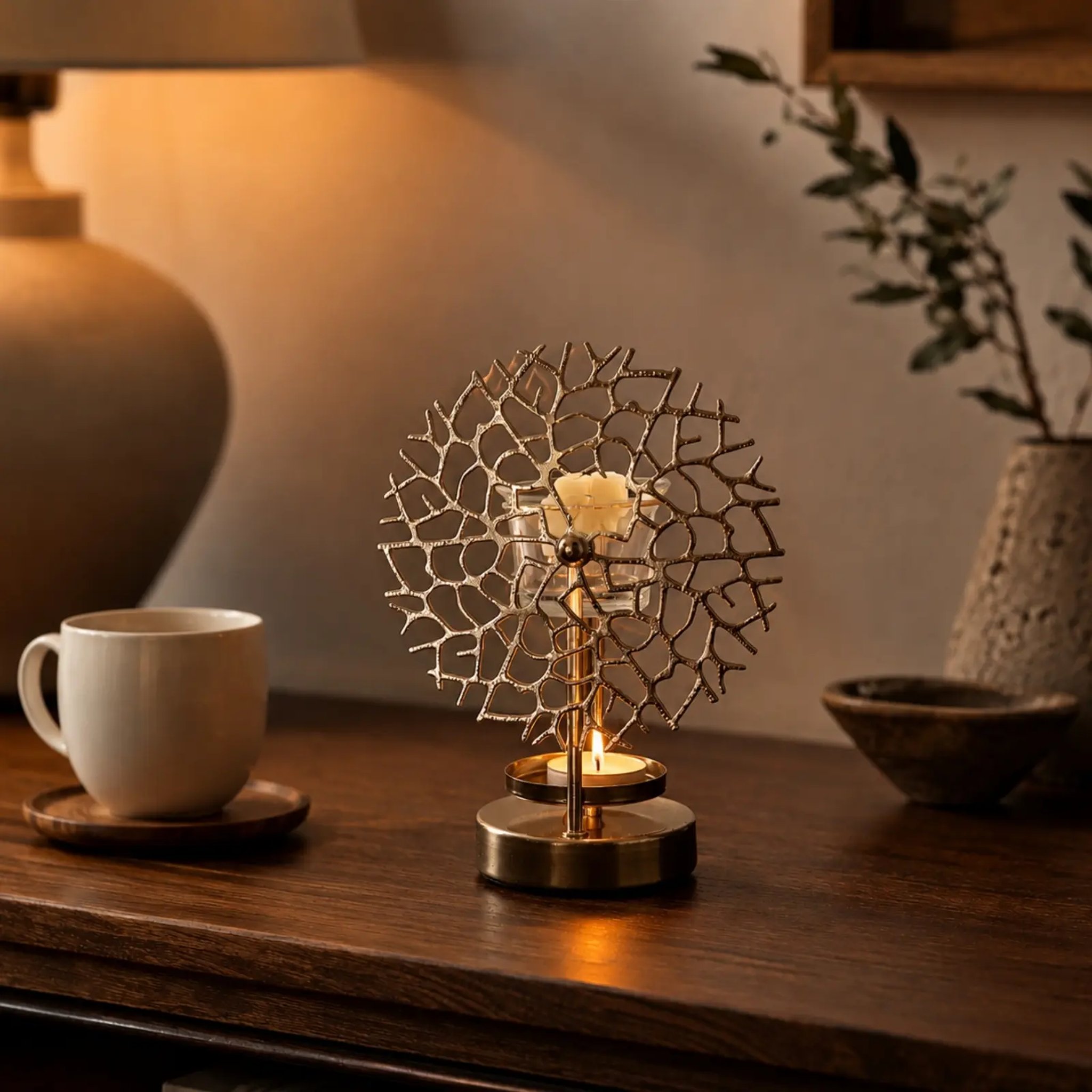 Oil burner with lit tealight and wax melt on a dark wooden table
