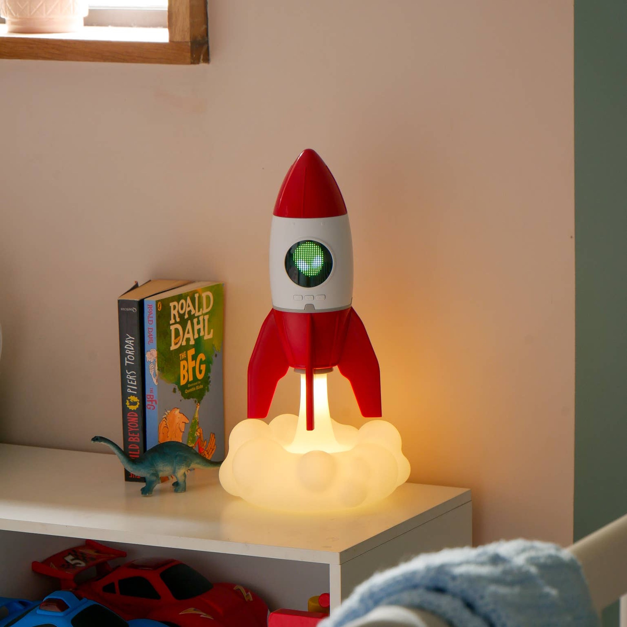 Rocket in a child's room, a green alien head glowing in the porthole