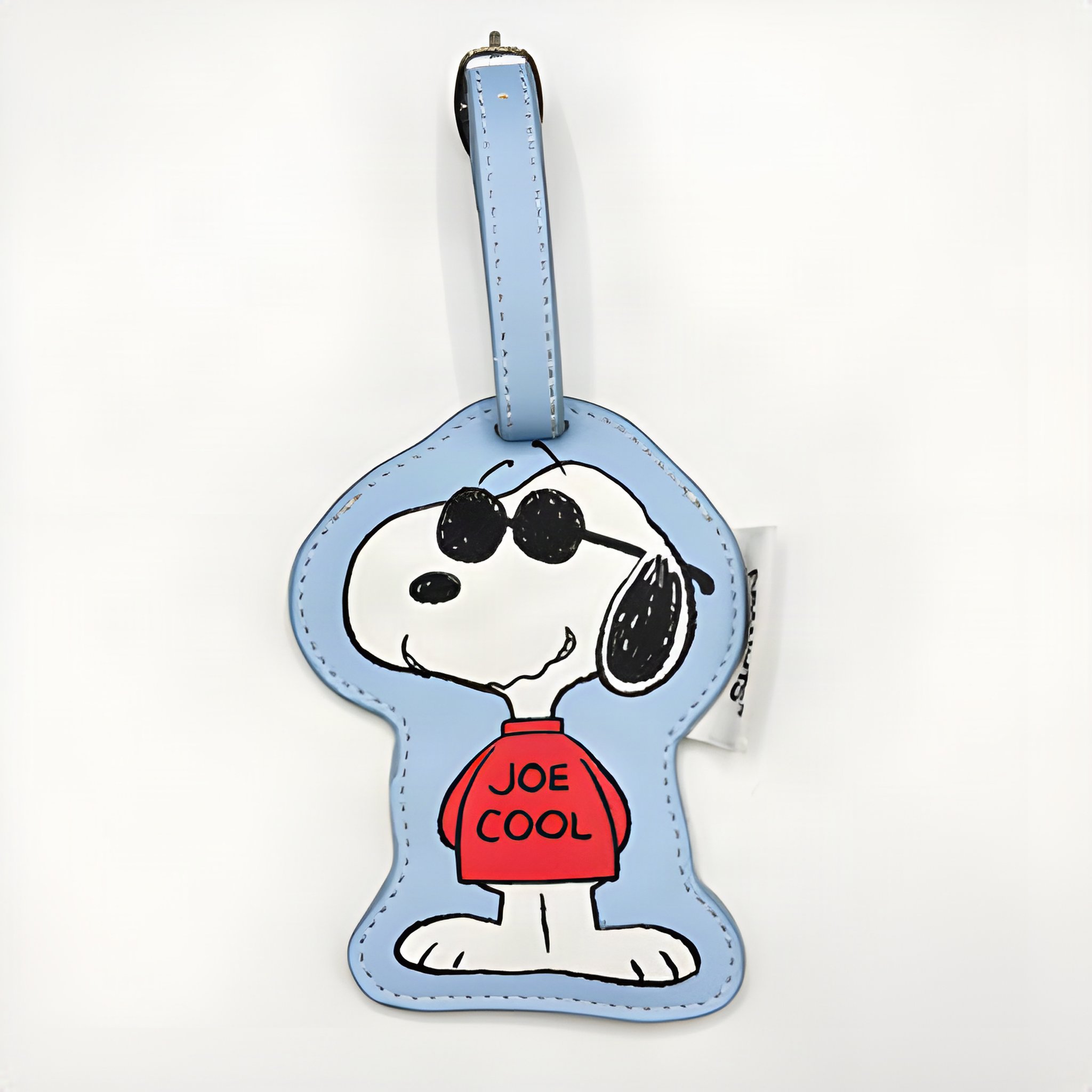 Light blue Snoopy Joe Cool luggage tag on a white background