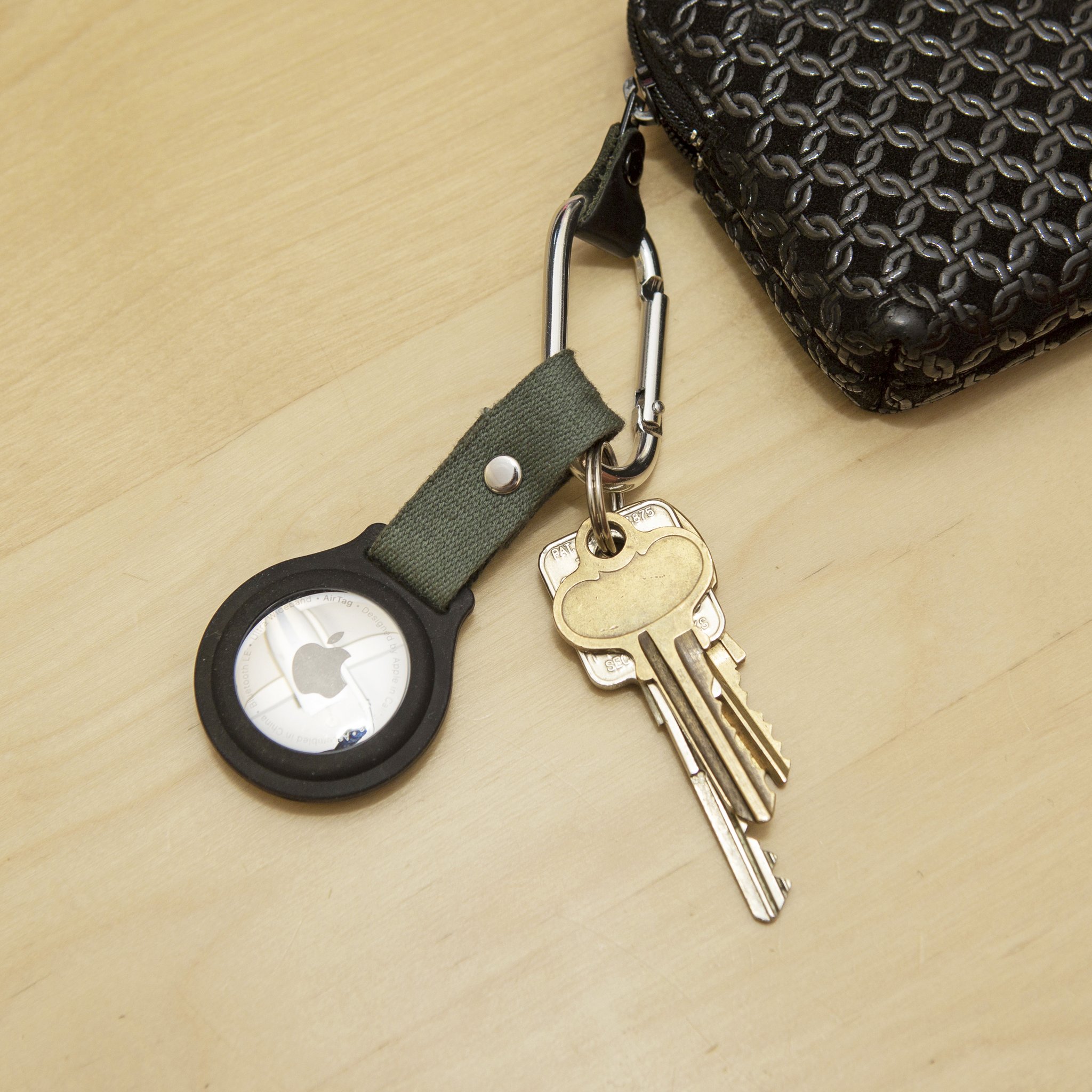 AirTag-Halter mit Karabiner und Schlüsselbund auf dem Tisch