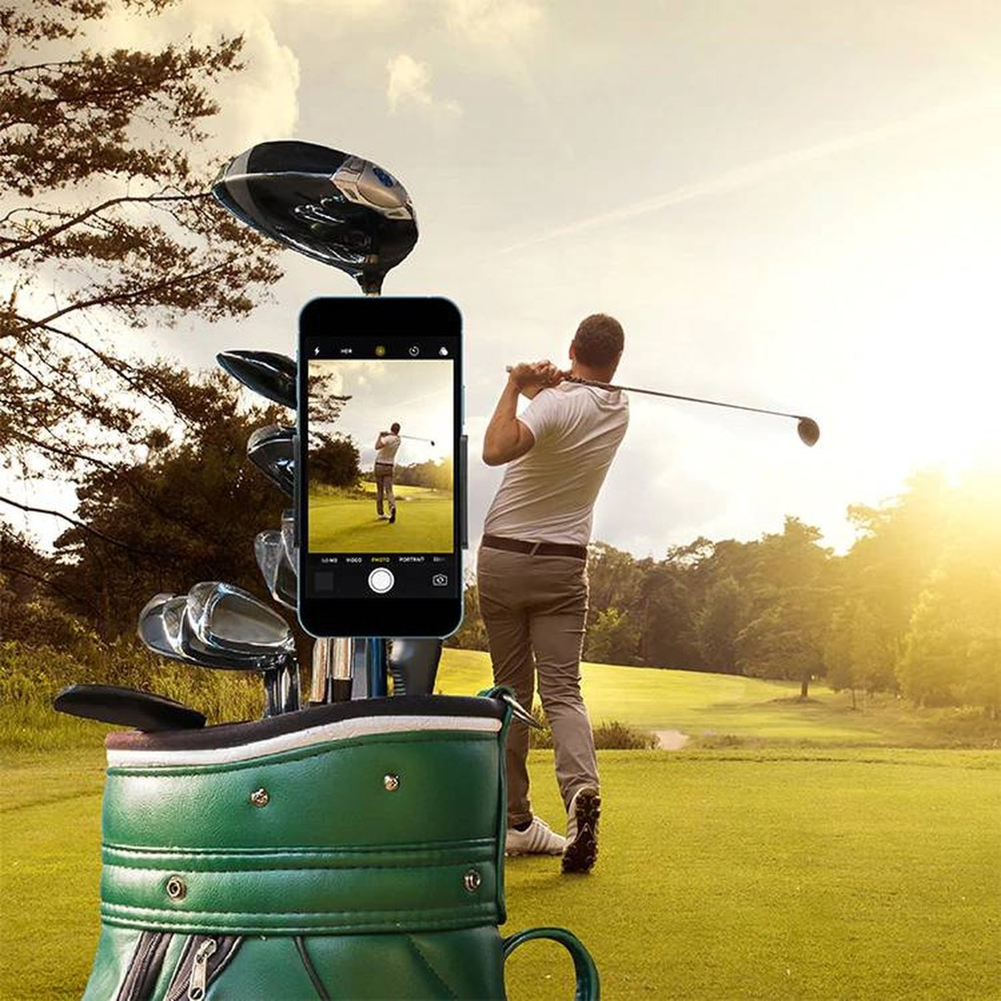 Golfer beim Abschlag, Smartphone im Golf Selfie Clip am Golfbag filmt