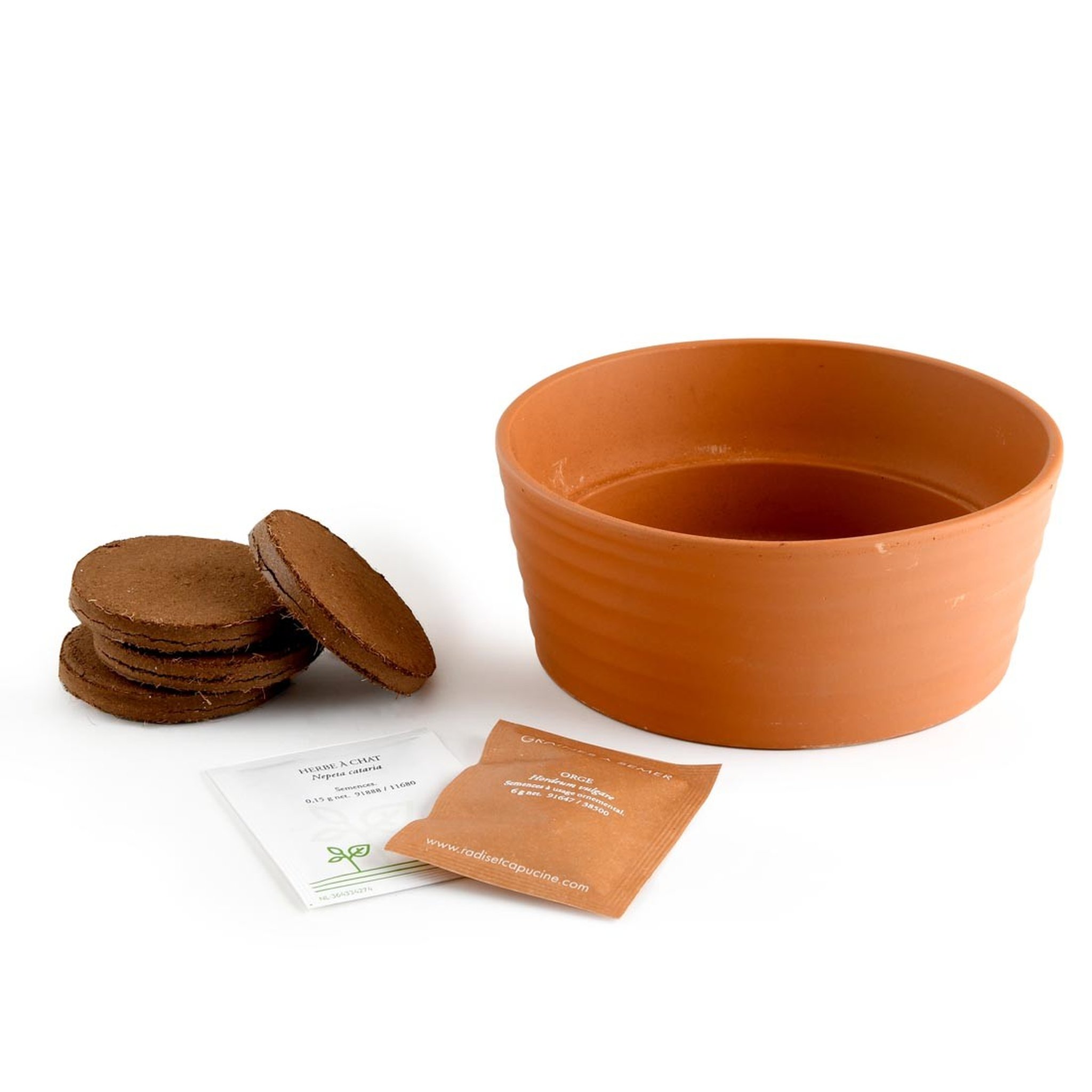 Terrakotta-Napf mit Kokoserde-Plättchen und Samenbeuteln