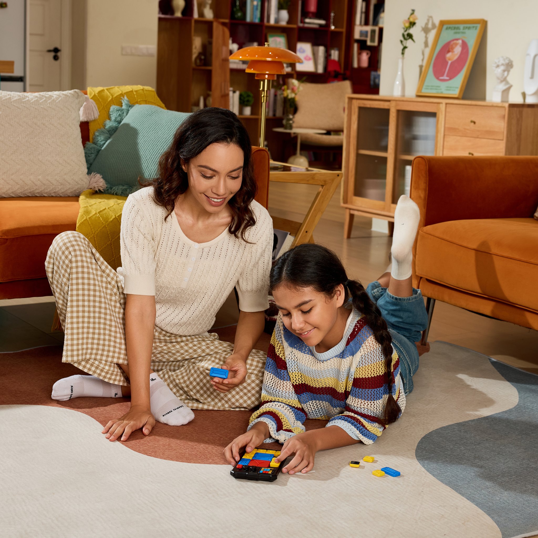 Mother and daughter solve a Super Slide puzzle together on the living-room floor.