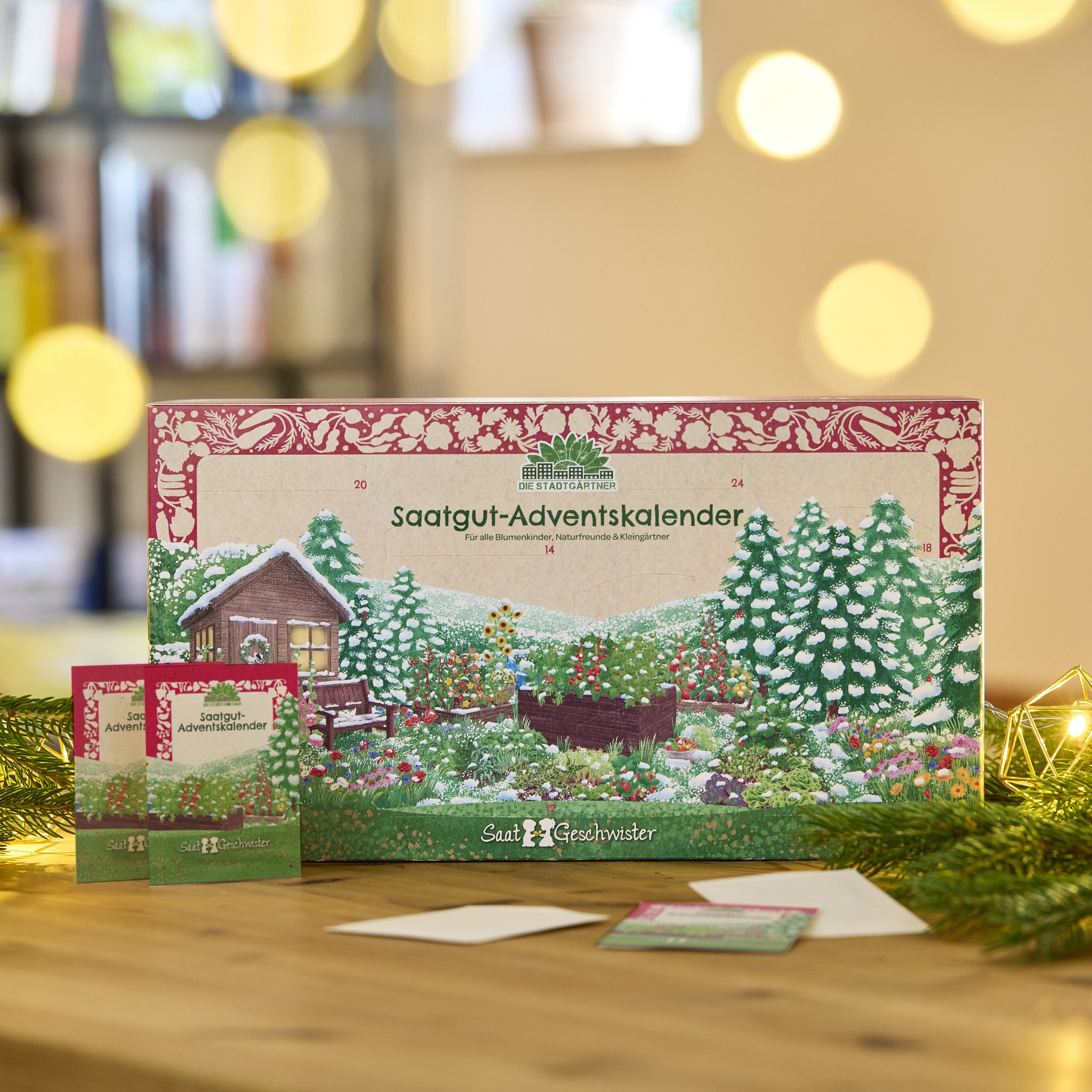 Seed advent calendar on a wooden table with fir branches and two seed packets in front