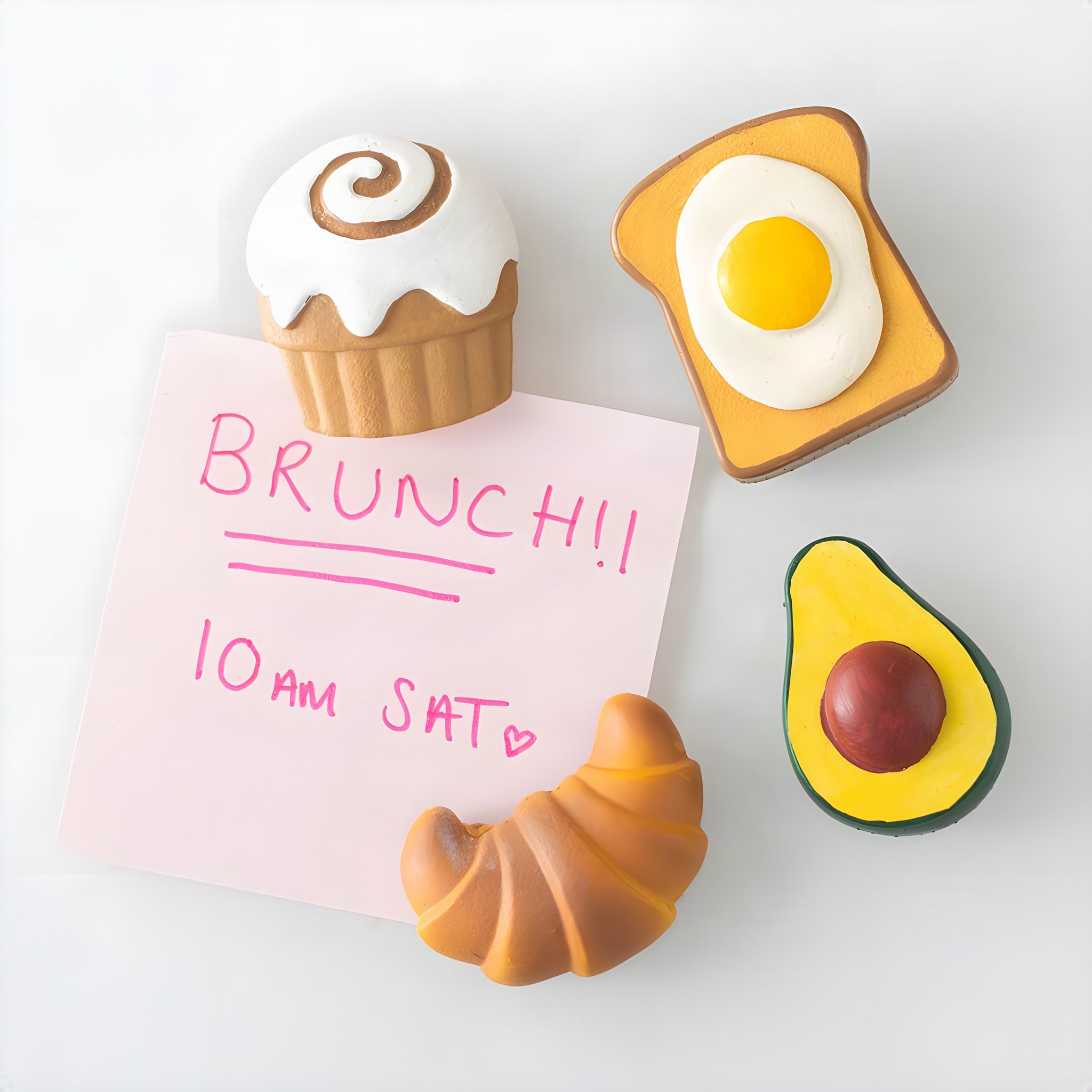 Brunch Club magnets holding a sticky note with a brunch date on the fridge
