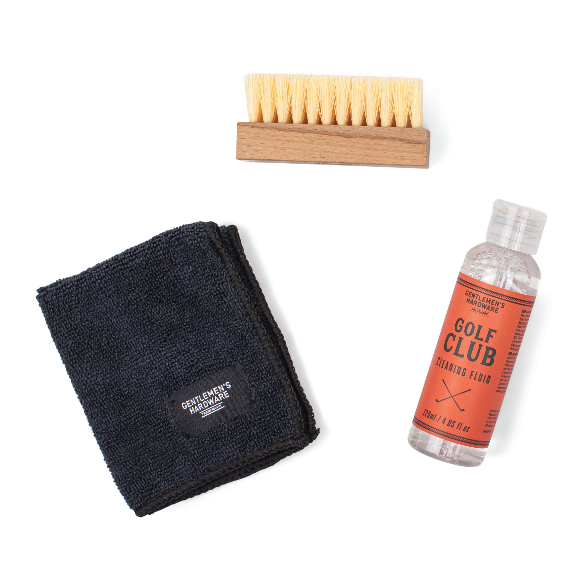 The three parts of the Golf Club Cleaning Set laid out: wooden brush, black cloth and bottle of cleaning fluid