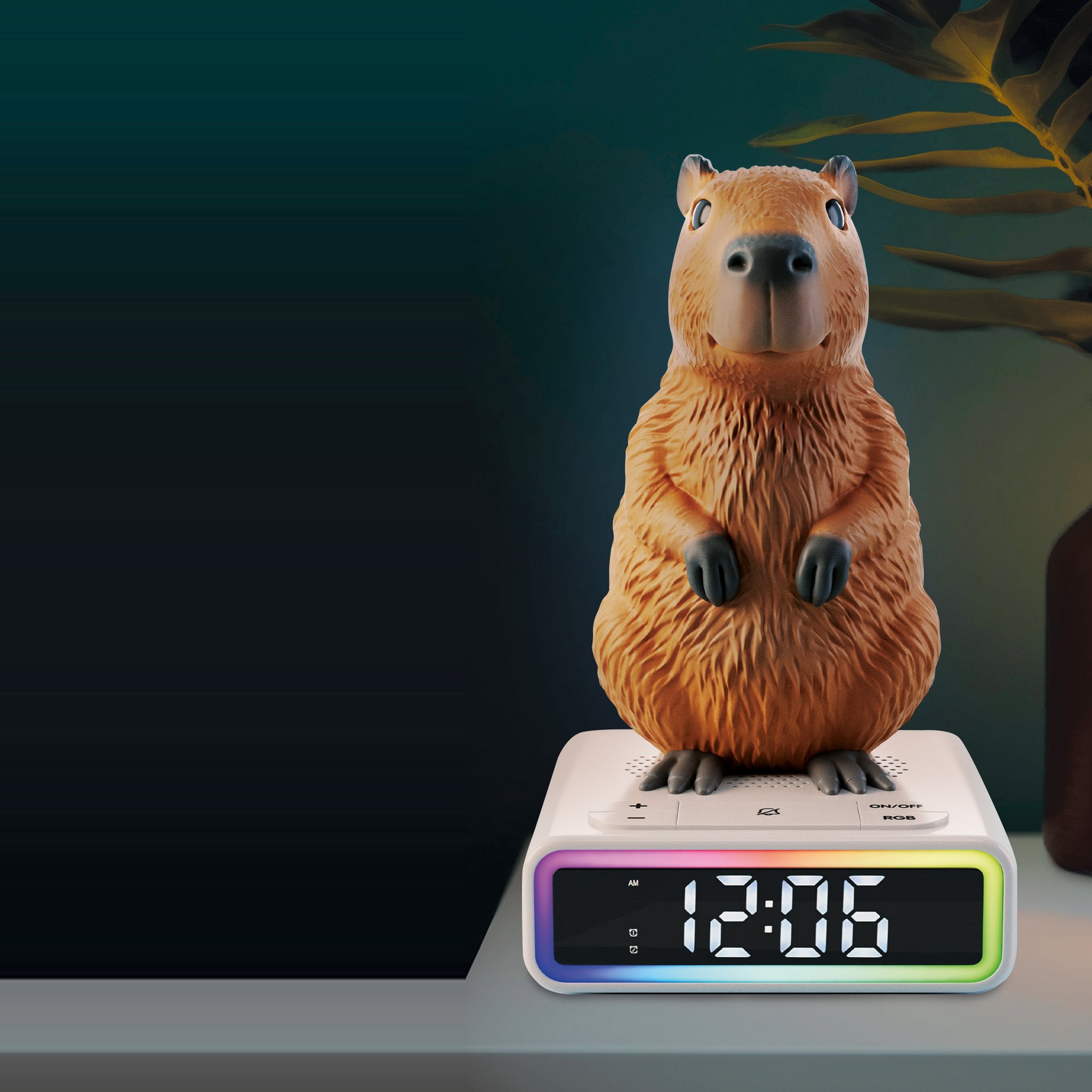 Capybara alarm clock on a bedside table in the evening, its light frame glowing in rainbow colours