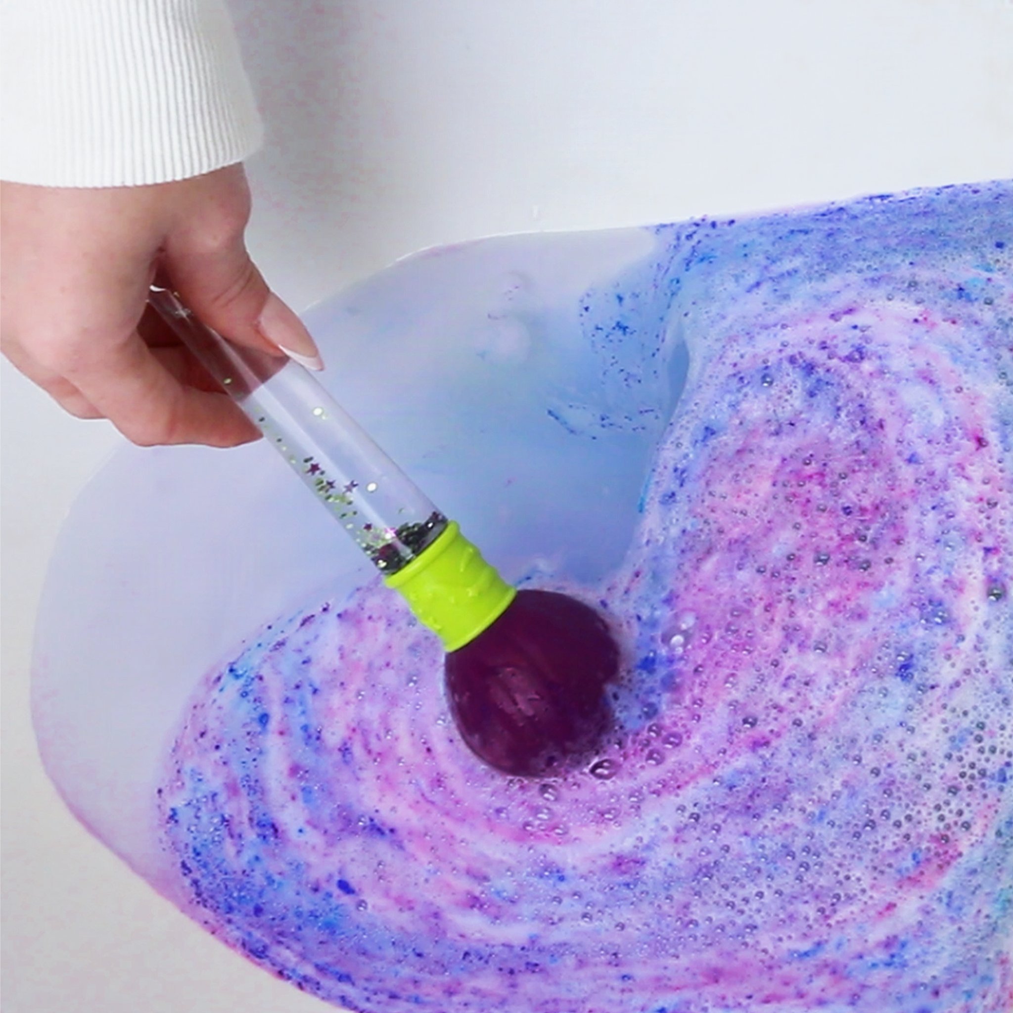 Purple and blue colour swirls in the bath water