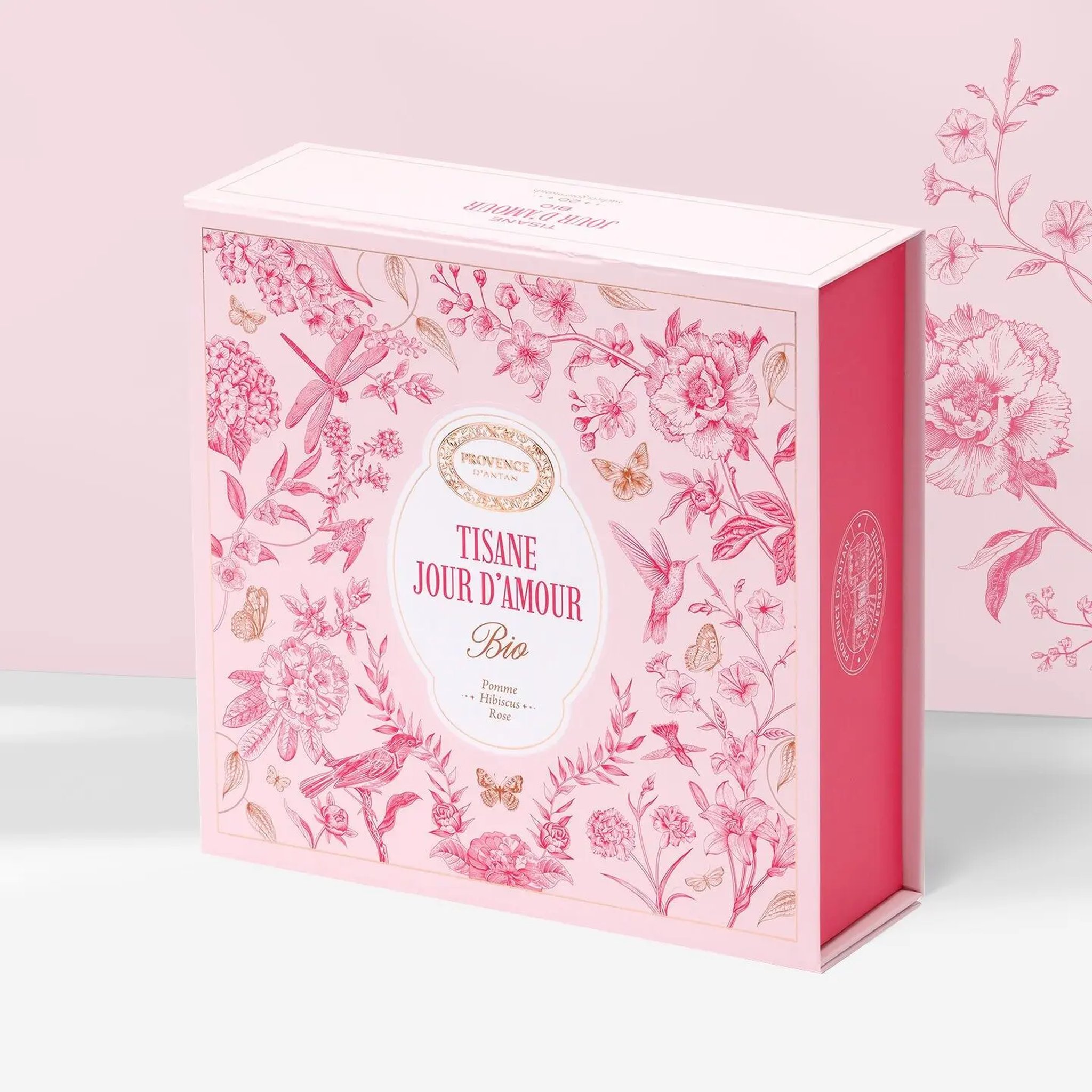 Closed magnetic box of Jour d'Amour herbal tea decorated with pink flowers and birds